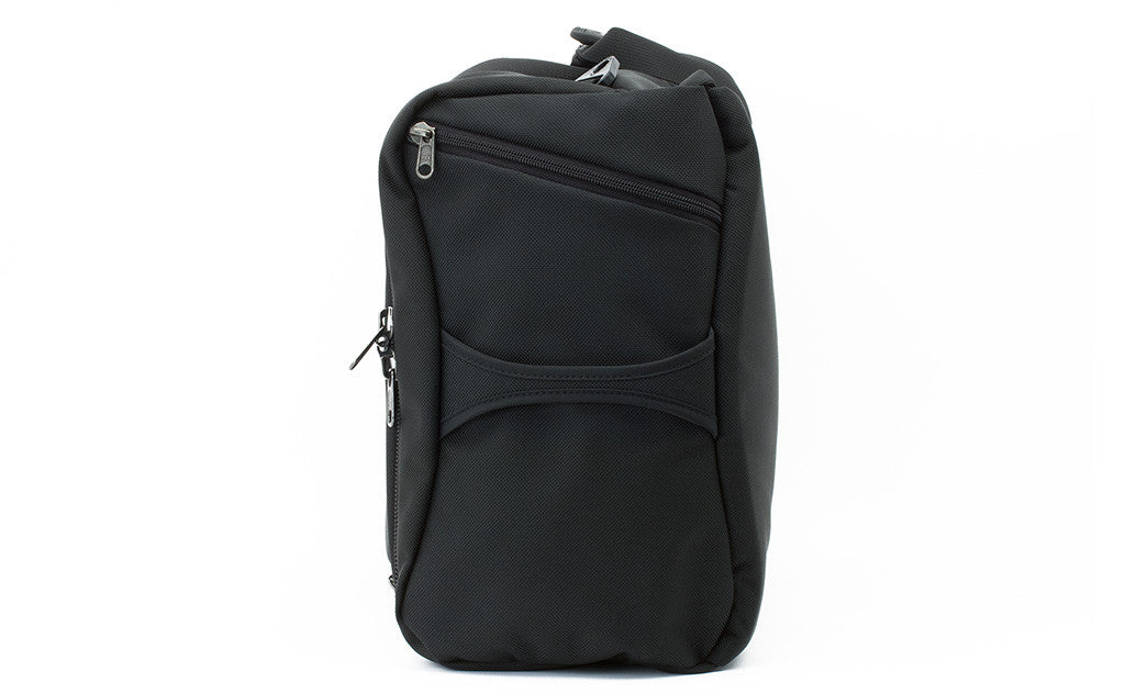 The slash or end pocket has a single zipper pull is placed on a bias starting at the top of the bag and extending toward the center where the grab handle is as it unzips.