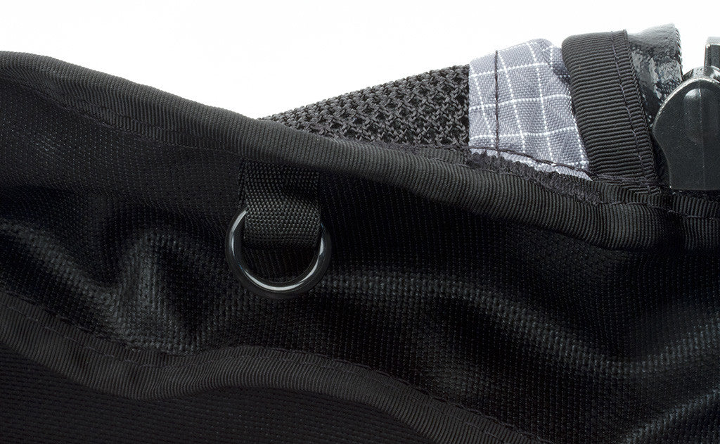 The o-rings are plastic rings that are hung or held in place by a loop of webbing sewn into the seam of the bag.