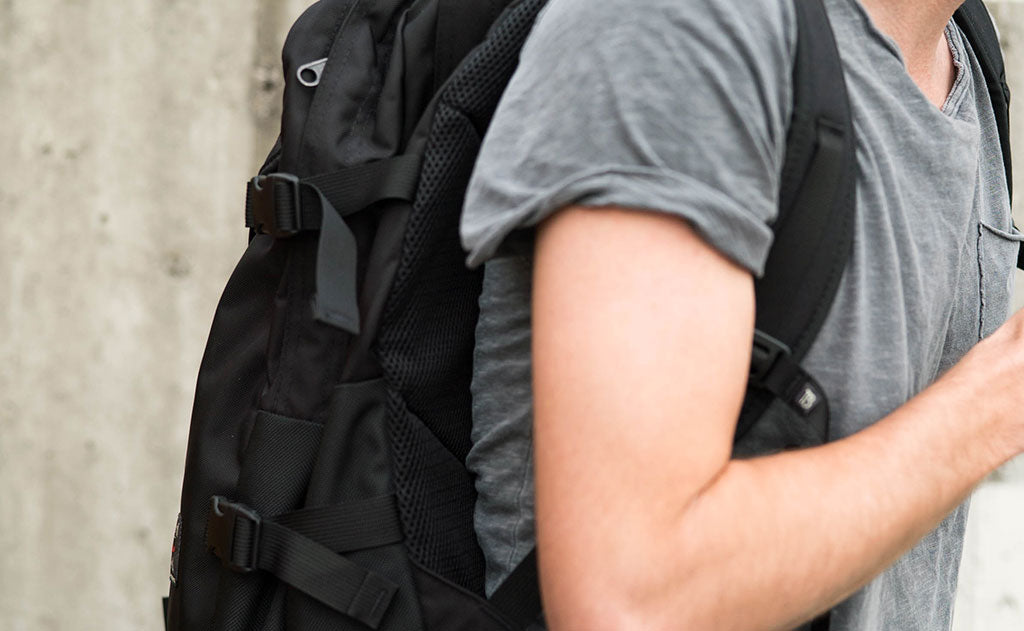 A tight shot of the shoulder strap on a person wearing the Brain Bag.0