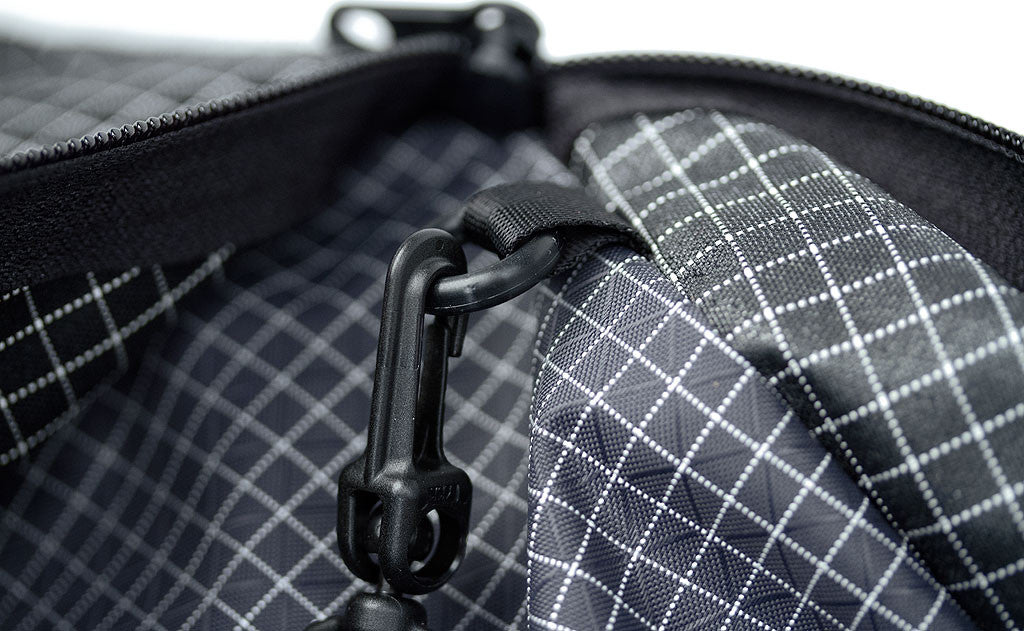 ^^Close shot of a snaphook attached to the o-ring in the front zippered pocket of the Daylight Backpack