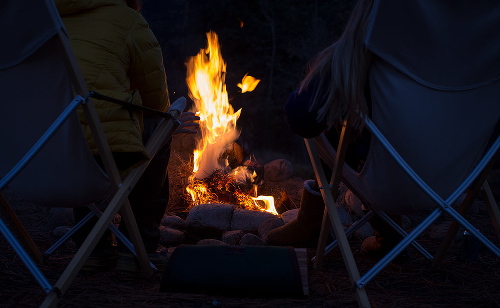 visible lifestyle^^A Firewood Carrier beside a stone circle campfire.