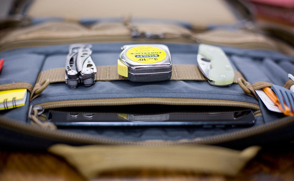 lifestyle visible^^A close shot of the webbing loops with tools attached on the interior of the Founder's Briefcase.