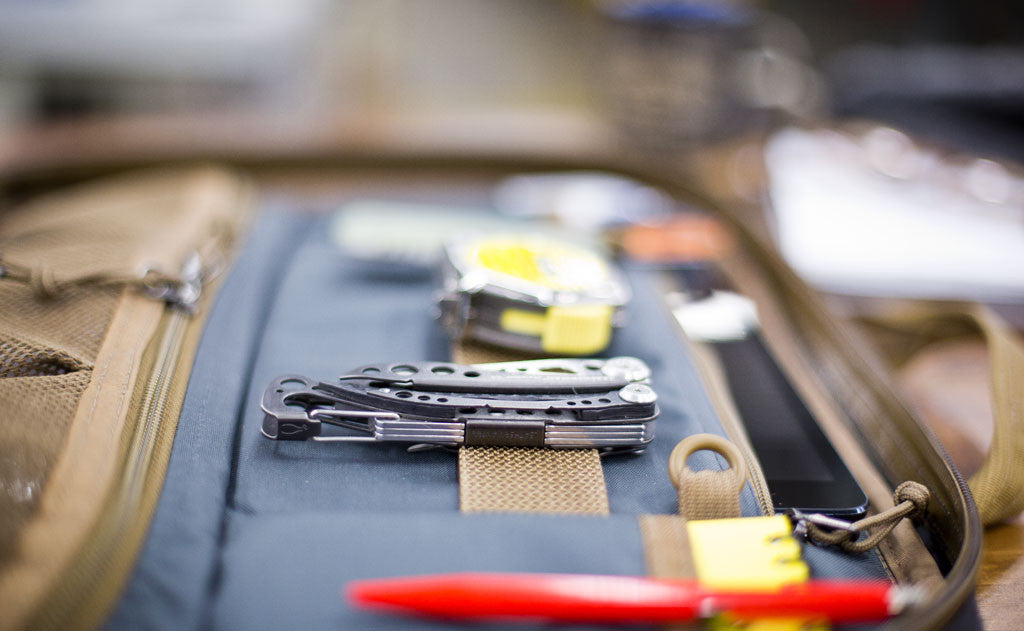 lifestyle visible^^A close shot of the webbing loops with tools attached on the interior of the Founder's Briefcase.