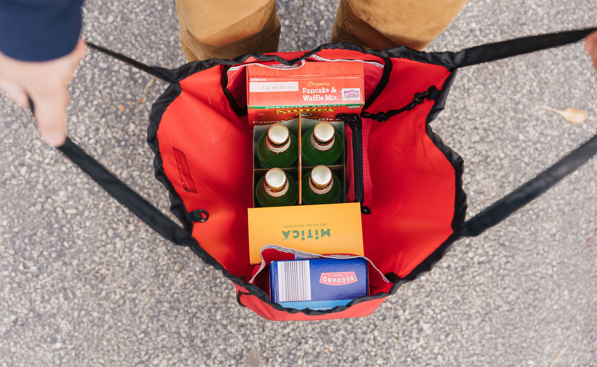 lifestyle visible^^ person carrying beer and snacks using red open tote bag