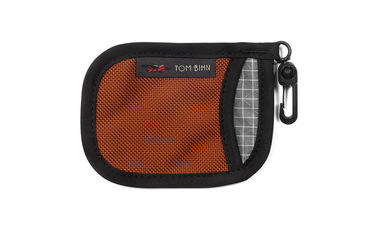 visible variant TB1229-TBND^^A Pocket Pouch in Burnt Orange with a Northwest Sky interior.