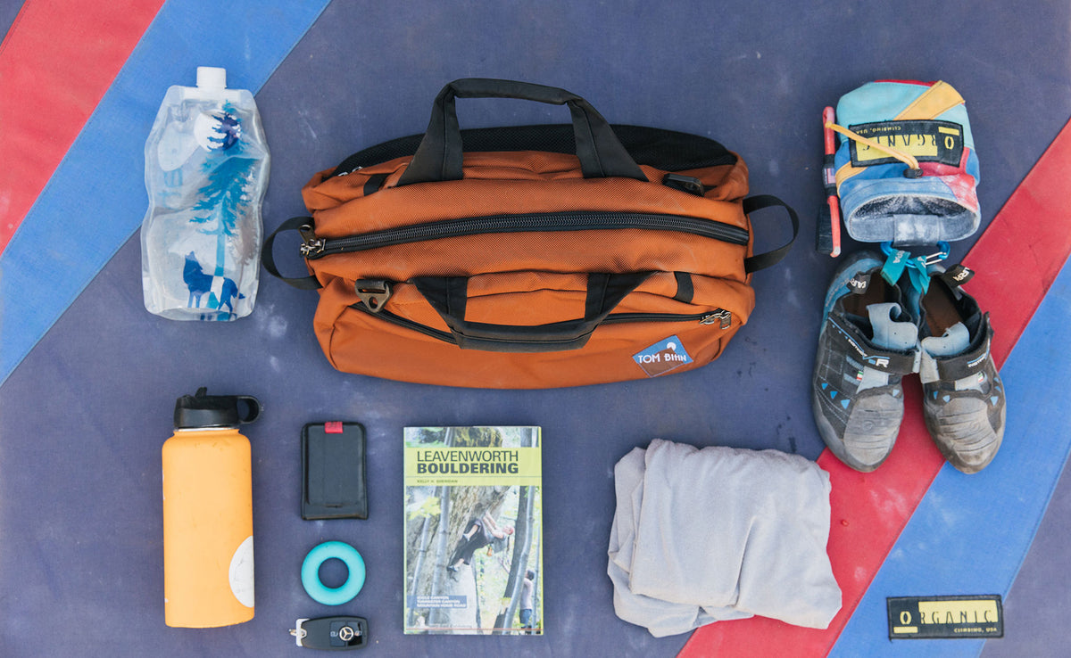 visible lifestyle^^Old School Carry-All in Burnt Orange with climbing gear around it.
