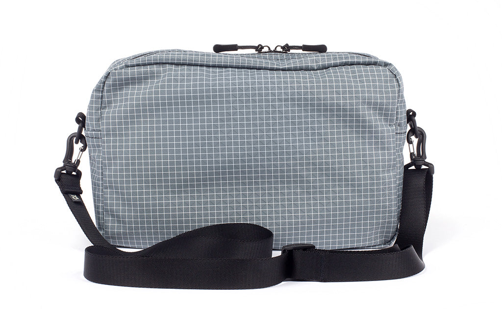 A reverse shot of the Packing Cube Shoulder Bag with a 1" shoulder strap attached