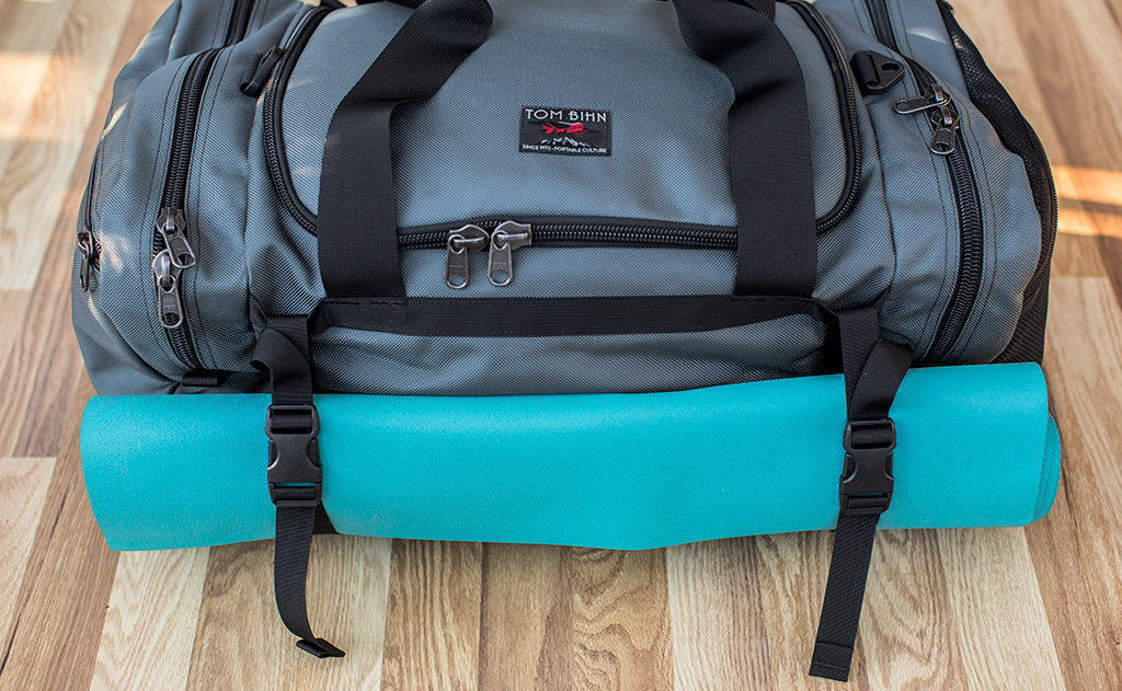 lifestyle visible^^The Road Buddy Lash Straps holding a rolled yoga mat.