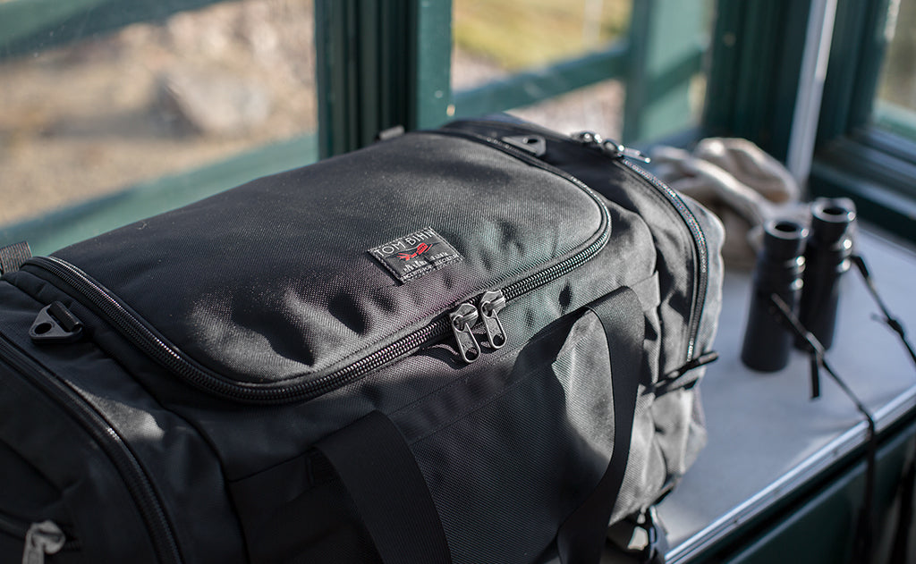 lifestyle visible^^A Road Buddy Duffel 60 in a fire lookout tower.