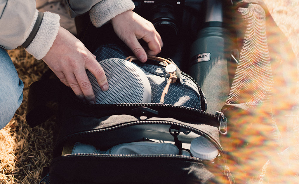 lifestyle visible^^A person accessing the Road Buddy Duffel's main compartment.