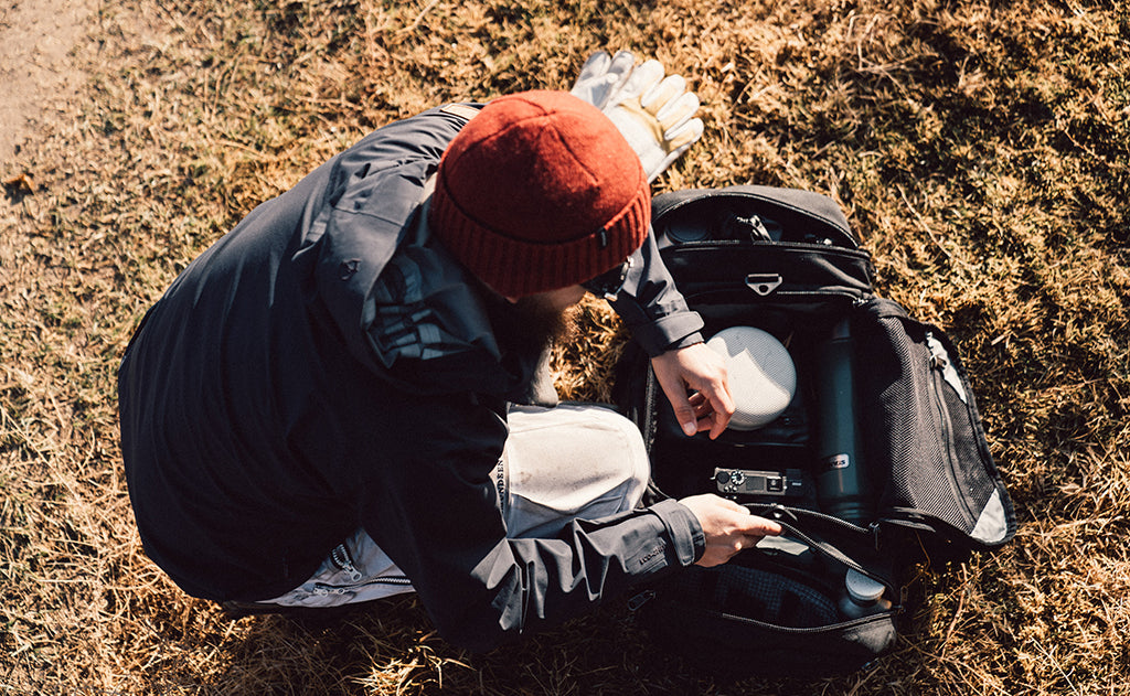 lifestyle visible^^A person accessing the Road Buddy Duffel's main compartment.