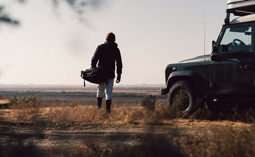 lifestyle visible^^A person carrying the Road Buddy Duffel 60 via the padded carry handle.