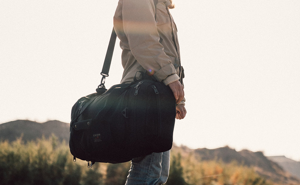 lifestyle visible^^A person carrying the Road Buddy Duffel via the included Shoulder Strap.