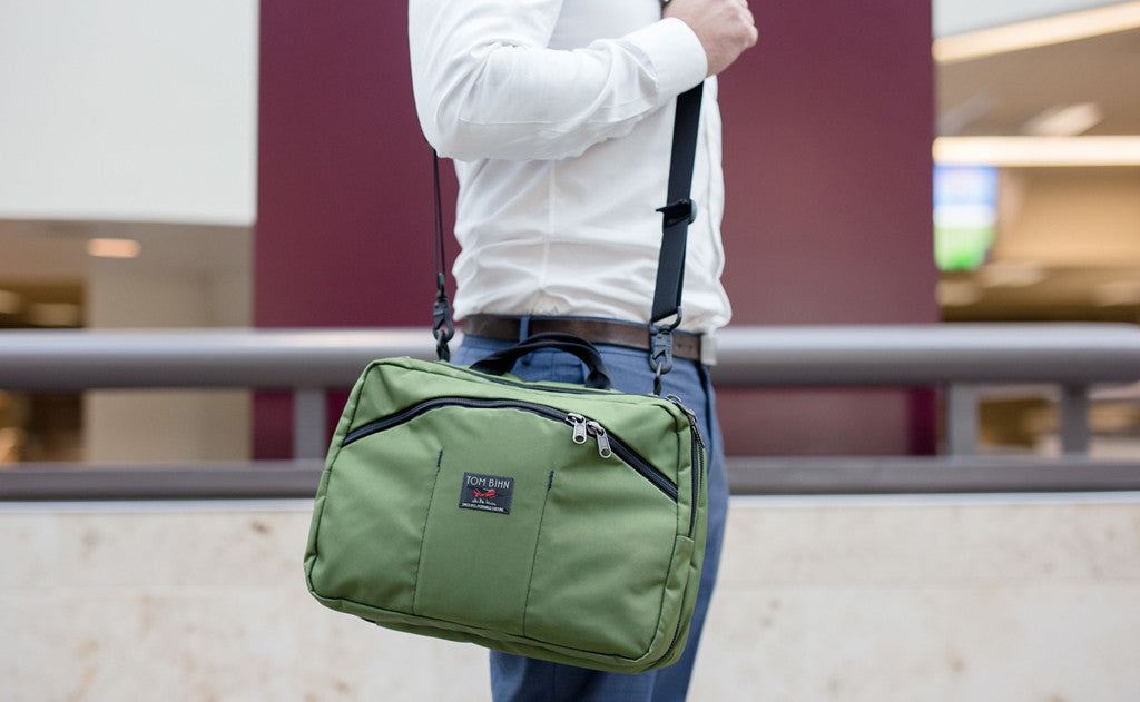lifestyle visible^^A person on an escalator carrying The Stowaway via a shoulder strap.