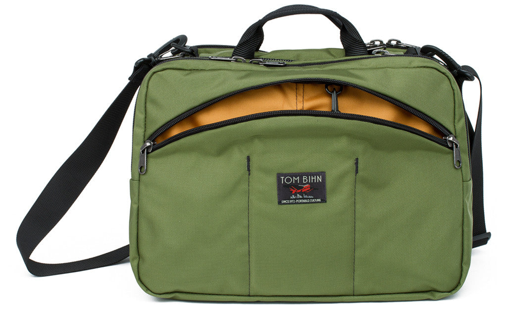 visible variant TB0975-OKYJ^^The Stowaway in Olive (green) 525 Ballistic with a Canyon (goldenrod yellow) 210 Ballistic interior..