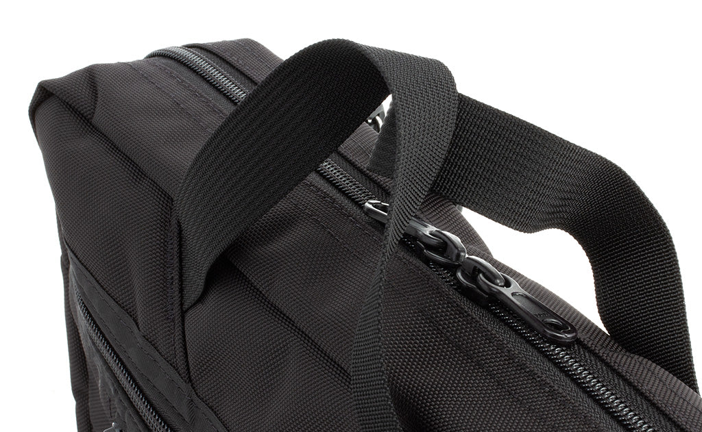detail visible^^A close shot of the top of the Daylight Briefcase showing the main compartment zippers, and the front zippered compartment