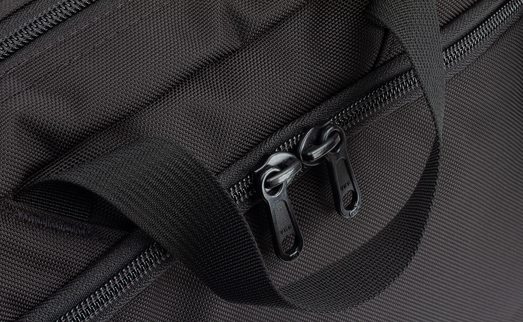 detail visible^^A close shot of the nylon carry handle and the front zippered compartment