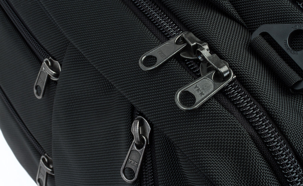 A close shot of the regular zippers of the front pockets and locking zippers on the main compartment of the Western Flyer.