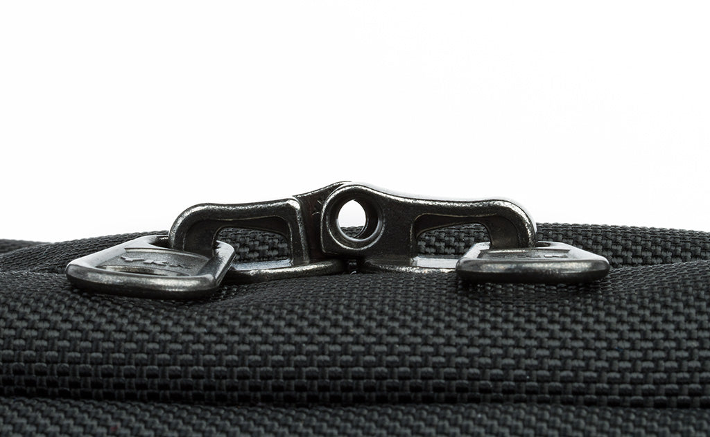 The locking zippers on a Black 525 Ballistic Western Flyer zipped shut to show the individual openings on each of the two zippers pairing together to create a slot for a travel lock.