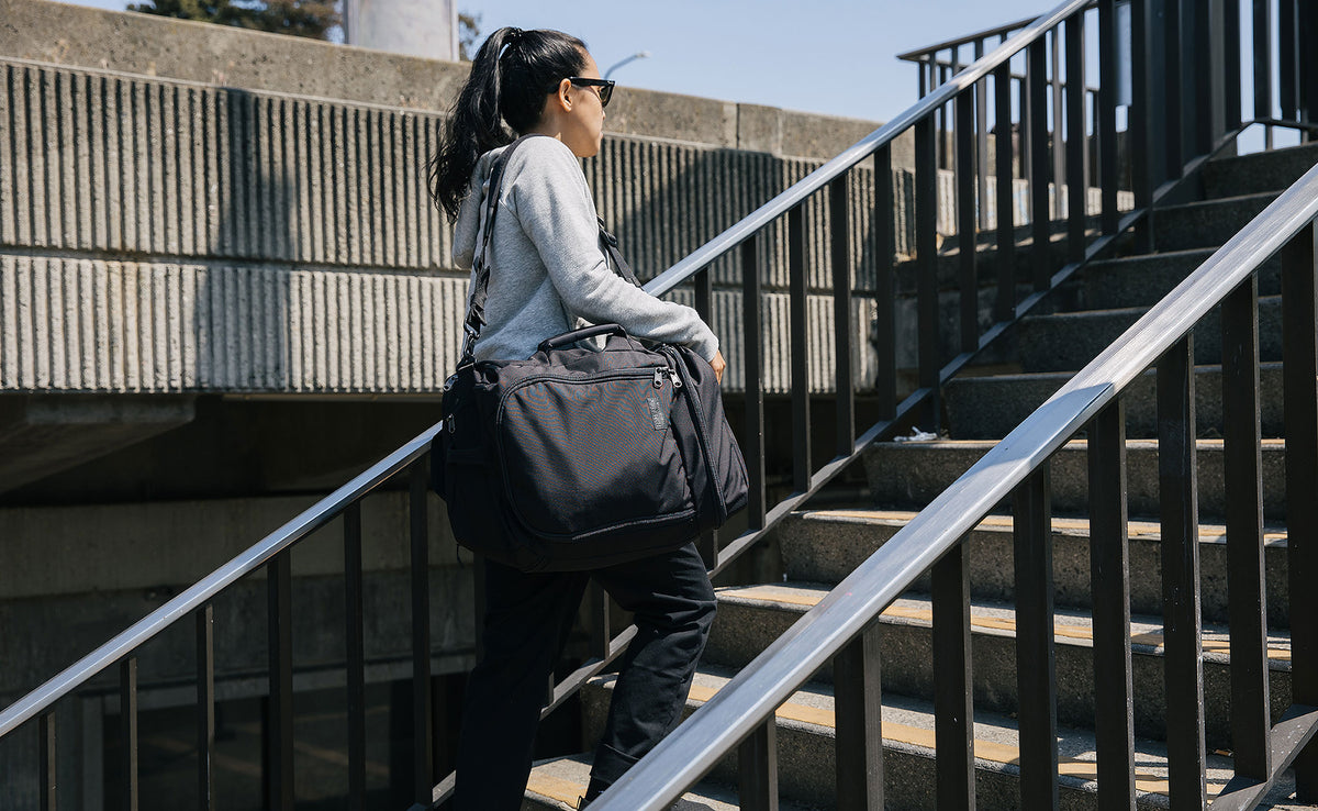 A person carrying the Techonaut 30 with a shoulder strap.