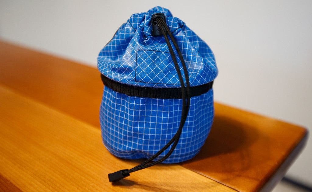 ^A Small Travel Tray with the top flipped up and the pull cord tightened.