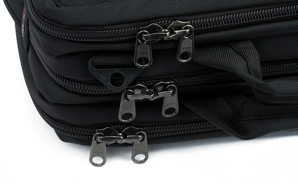 ^A close shot of the three main pockets and their locking zippers.