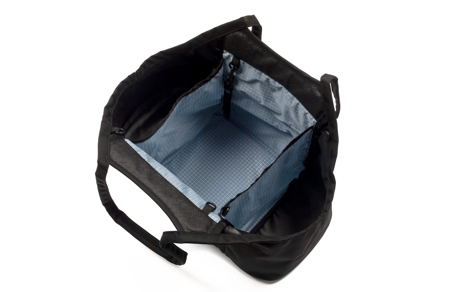 visible variant TB0619-BK7D^^The Truckasana in Black/Tidal blue. Top-down photo shows the empty bag with its three compartments.