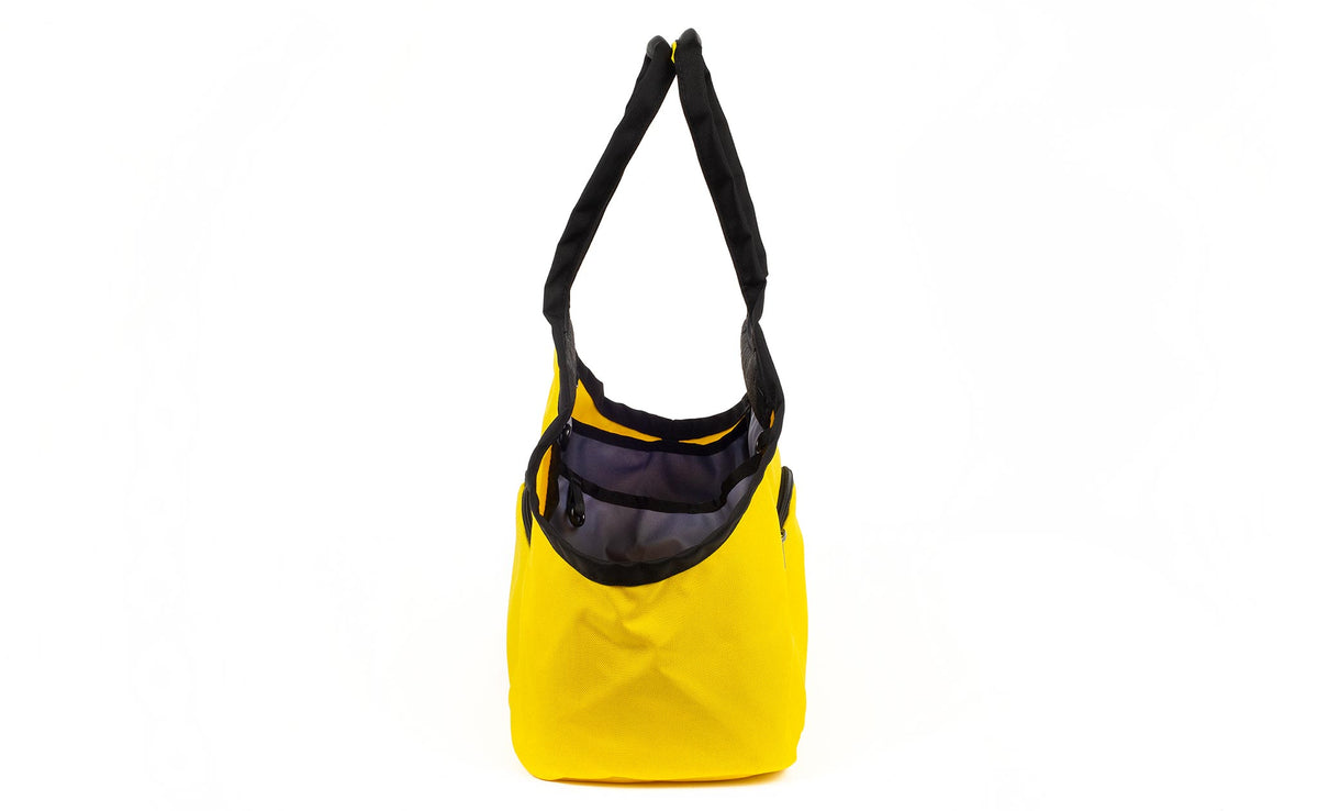 visible variant TB0619-YCDJ^^The Truckasana in Canary yellow and Dawn lining. Side view of the bag.