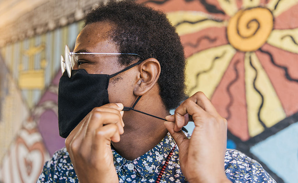 visible variant ME00009-BF^^Person adjusting the adjustable ear loops/lanyard of the V4 Mask.