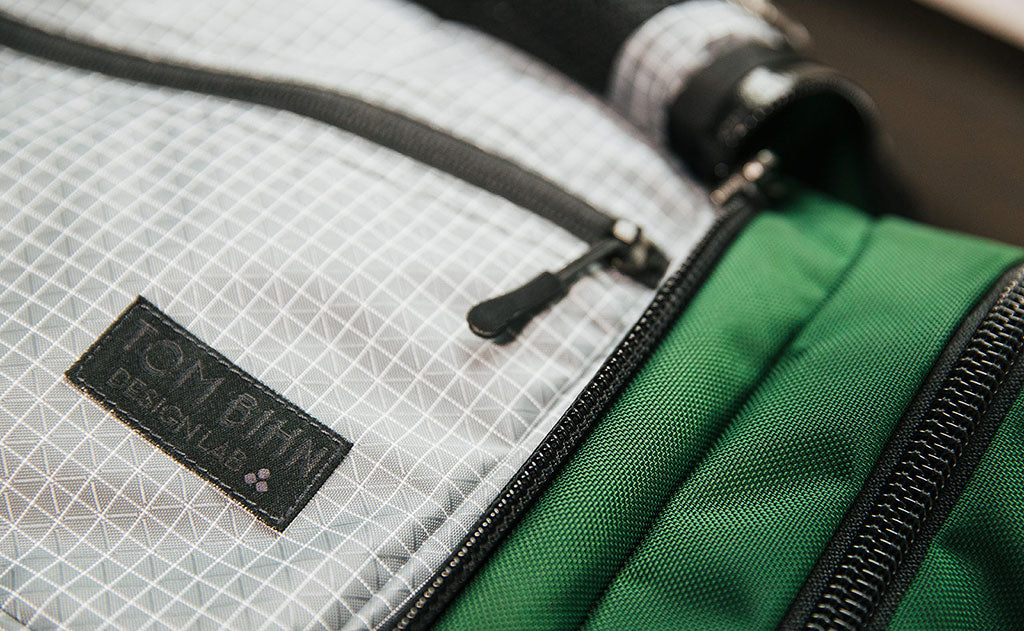 lifestyle visible^^Design Lab Edition Packing Cube Shoulder Bag being packed in an Aeronaut 45 travel bag.