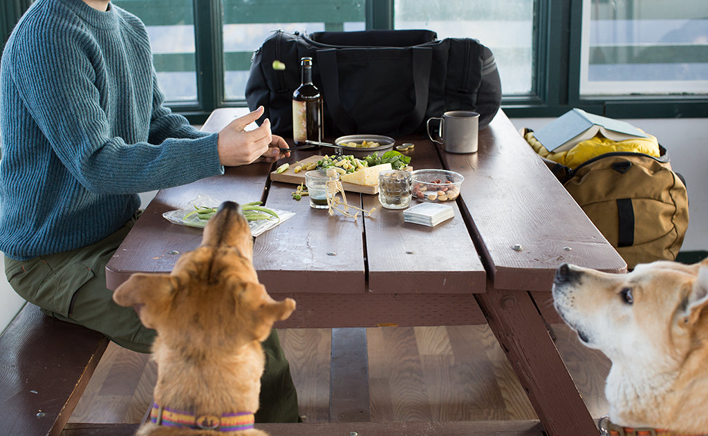 lifestyle visible^^A Road Buddy Duffel 60 on a camp table.