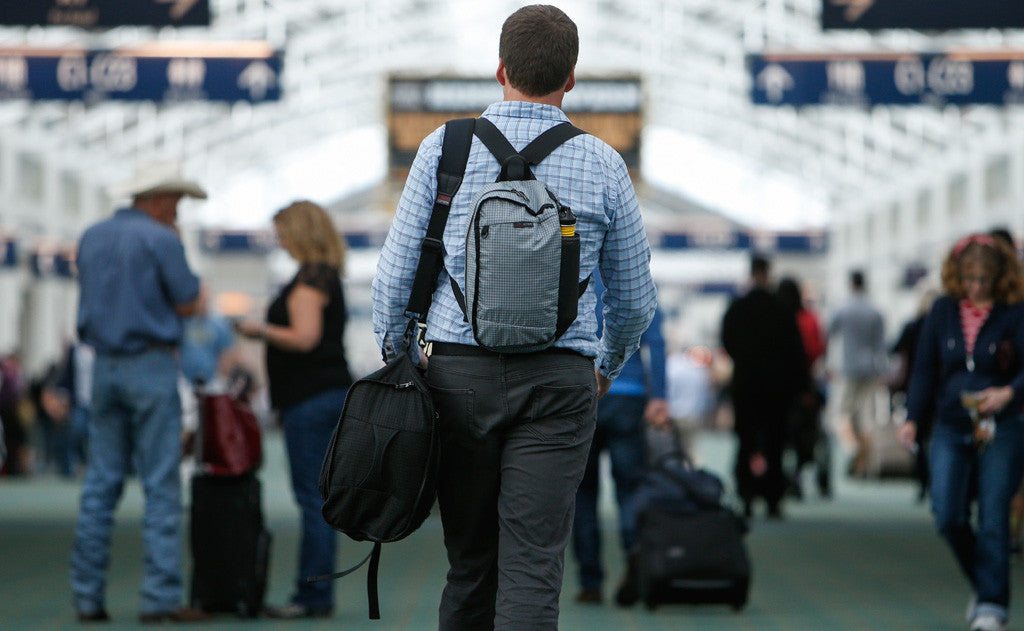 lifestyle visible^^A person carrying the Hero's Journey main bag as a shoulder bag and the Hero's Journey top pocket as a backpack.