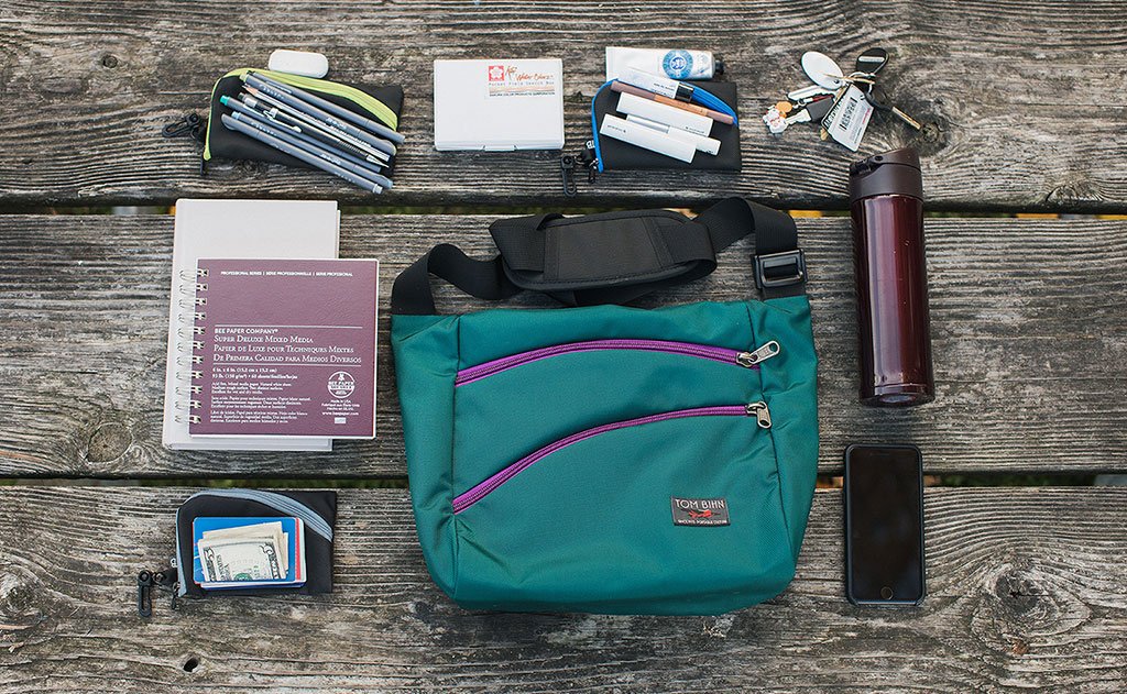 lifestyle visible^^A possible loadout for an Icon -- a water bottle, keys, a couple of organizer pouches, an A5 pad of paper and a cellphone.