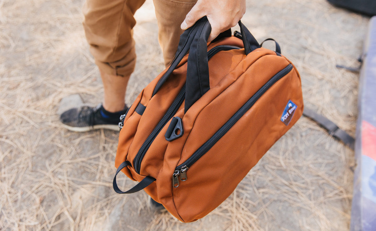 visible lifestyle^^A person carrying the Old School Carry All by its handles