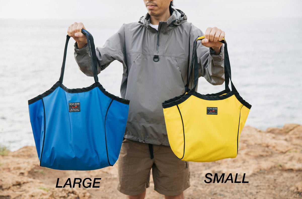 lifestyle visible^^Person holding the Large Original Shop Bag on the left and the Small Original Shop Bag on the right.