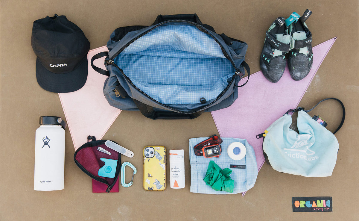 visible lifestyle^^Load out photo that shows the main compartment of the OSCA wide open and various climbing gear laid out around it.