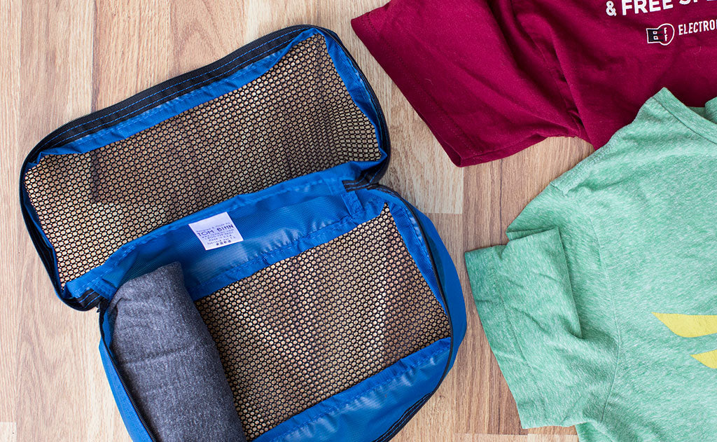 ^^Rolled shirts placed into a Small Western Flyer Packing Cube in Island (blue) 120 Aether.