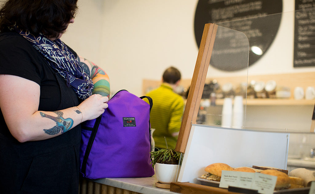 ^^A person accessing the main compartment of the Pop Tote.