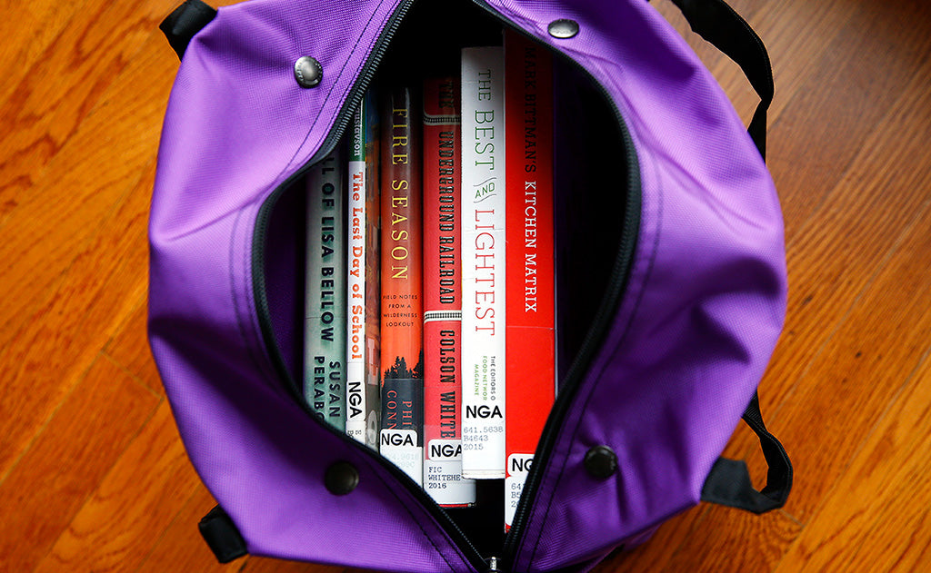 visible lifestyle^^A Pop Tote filled with books.