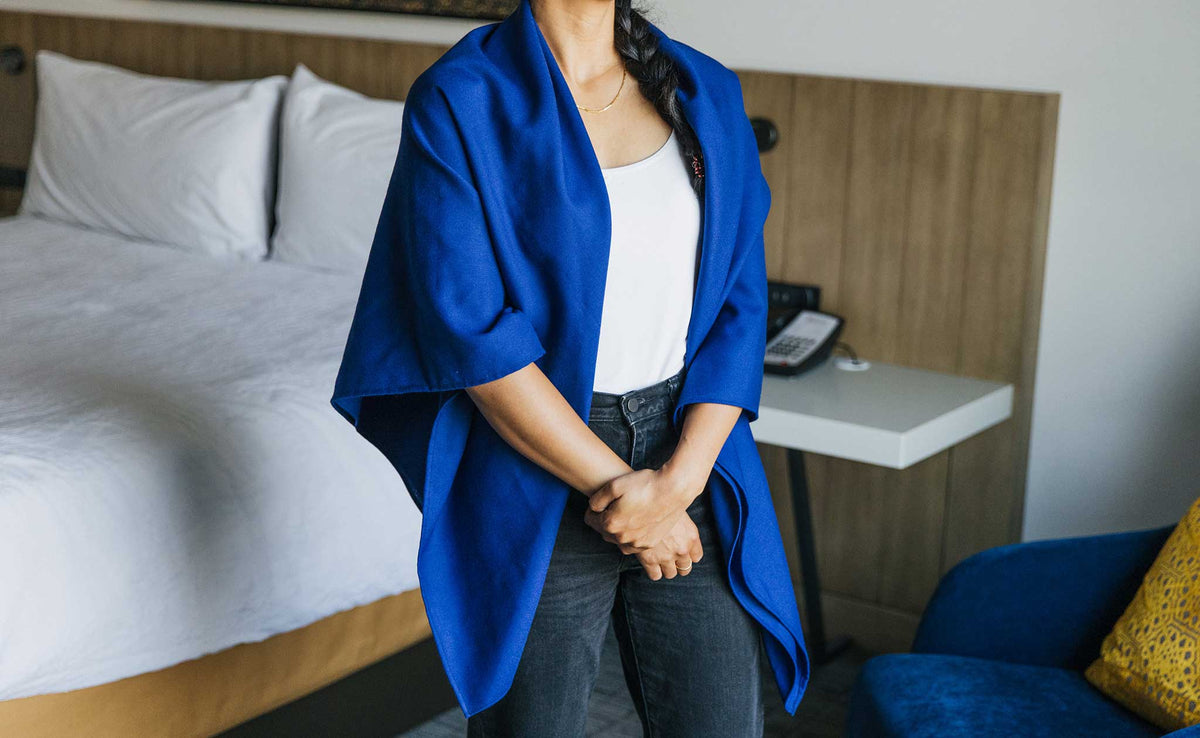 ifestyle visible^^ A Large Shepherd's Wool Utility Cloth in Neela Blue being worn by a person as a shawl.