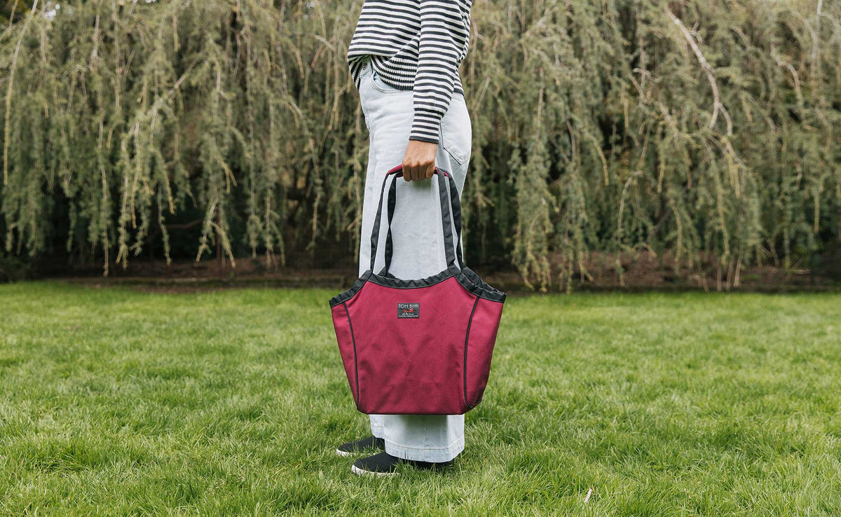 lifestyle visible^^Original Small Shop Bag in Red Blend, held in hand.
