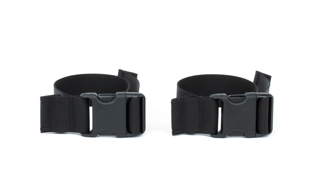 visible^^A pair of stroller/wheelchair adapter straps.