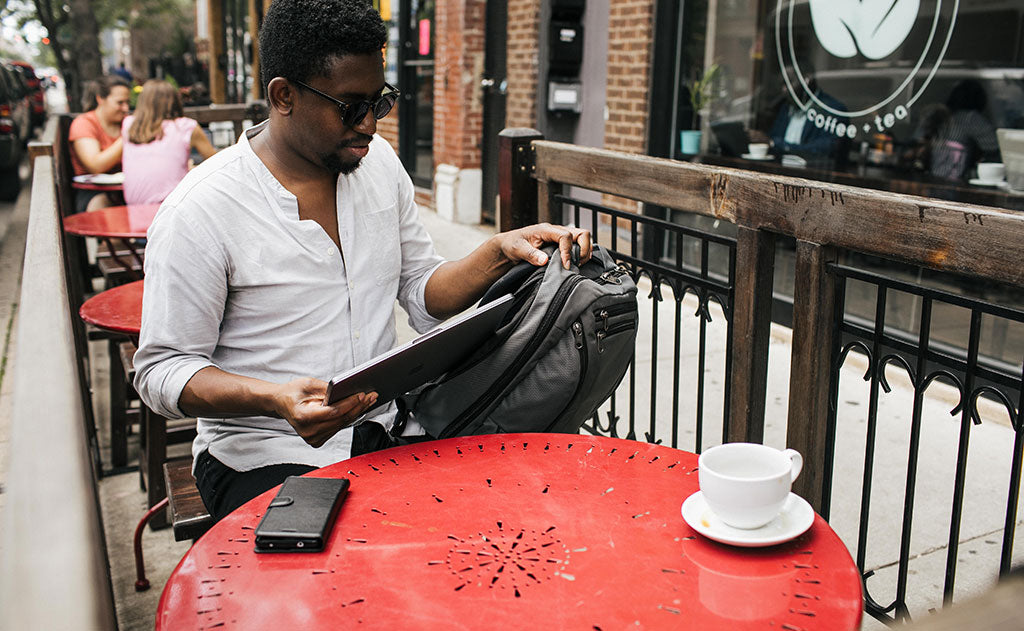 ^^person putting laptop into side laptop pocket