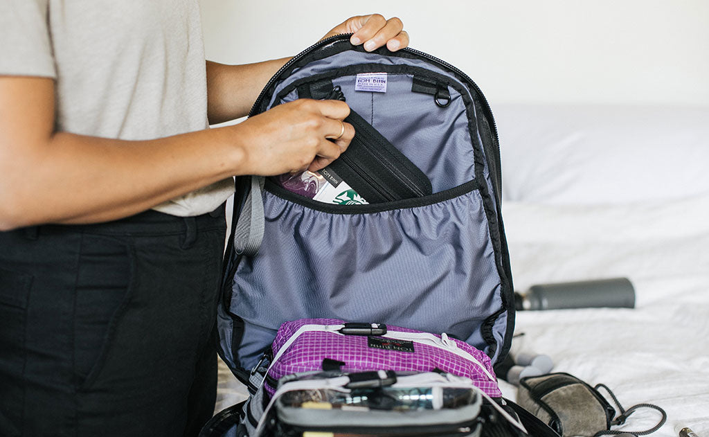 person clipping a pouch to an internal o-ring